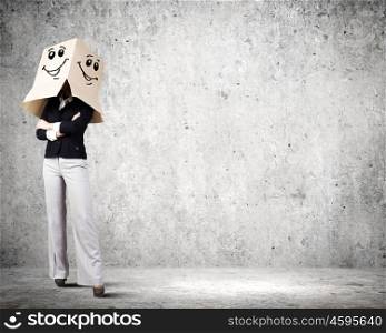 Hiding face. Confident businesswoman wearing carton box on head