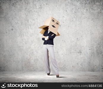 Hiding face. Confident businesswoman wearing carton box on head