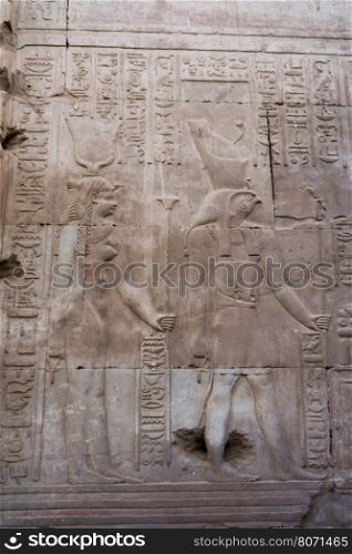 Hieroglyphic carvings on the exterior walls of egyptian temple