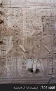 Hieroglyphic carvings on the exterior walls of egyptian temple