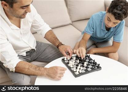 high angle adult kid playing chess