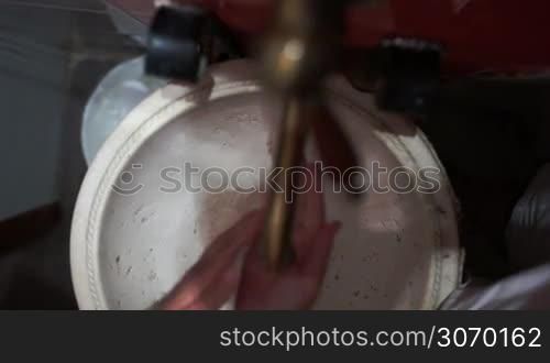 High angle and close-up shot of a woman washing hands in old vintage sink, shaking off water and turning off the tap