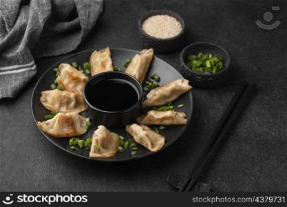 high angle asian dumplings dish with herbs