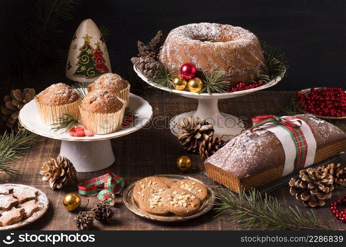 high angle assortment christmas desserts with pine cones red berries