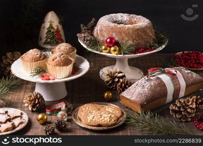 high angle assortment christmas desserts with pine cones red berries