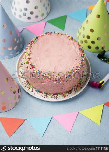 high angle assortment with party hats pink cake