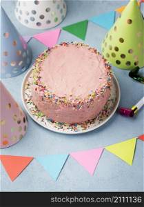 high angle assortment with party hats pink cake