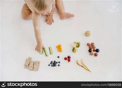 high angle baby choosing what eat alone. Resolution and high quality beautiful photo. high angle baby choosing what eat alone. High quality beautiful photo concept