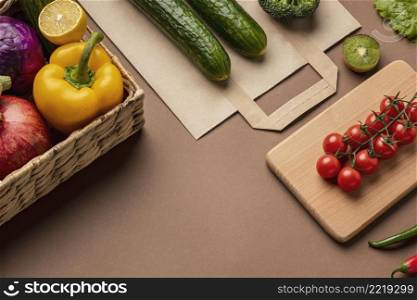 high angle basket organic vegetables with grocery bag
