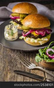 high angle beef burgers with pickles cutting board