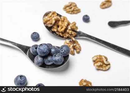 high angle blueberries walnuts spoons