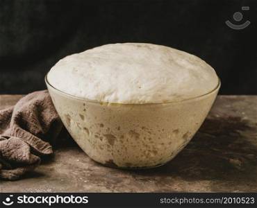 high angle bowl with growing dough pizza