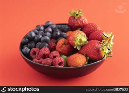 high angle bowl with strawberries blueberries raspberries