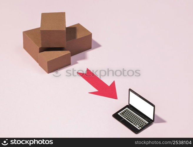 high angle boxes red arrow laptop