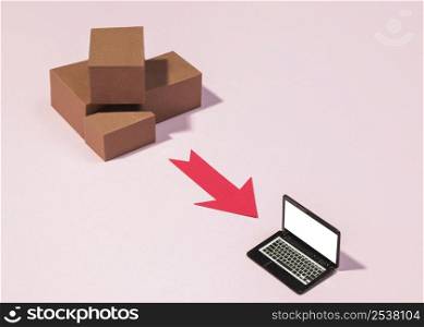high angle boxes red arrow laptop
