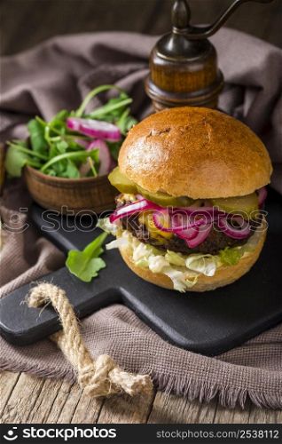 high angle burger with pickles cutting board