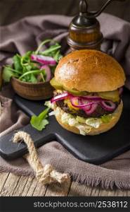 high angle burger with pickles cutting board