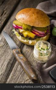high angle burger with pickles knife