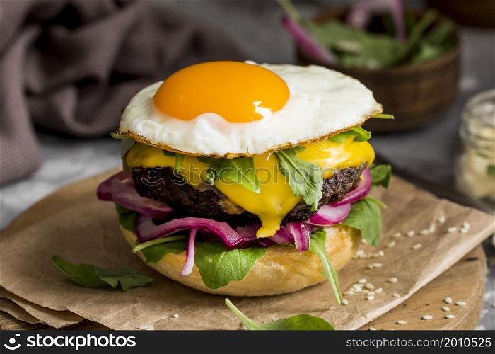 high angle cheeseburger with fried egg cutting board