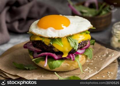 high angle cheeseburger with fried egg cutting board