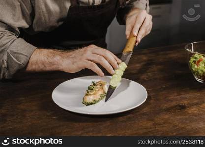 high angle chef plating meal