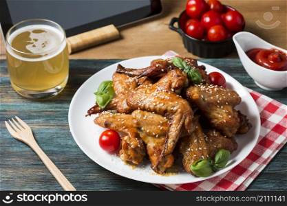 high angle chicken wings plate with cherry tomatoes