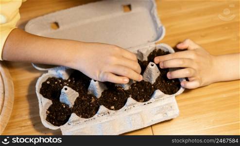 high angle children planting seeds home