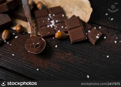 high angle chocolate bars spoon with cocoa powder