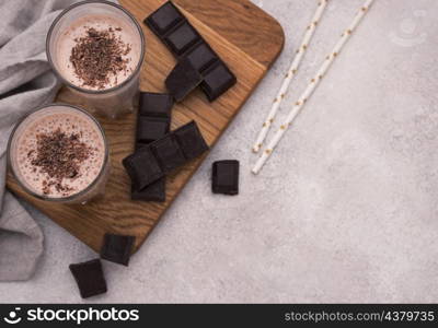 high angle chocolate milkshakes with straws copy space