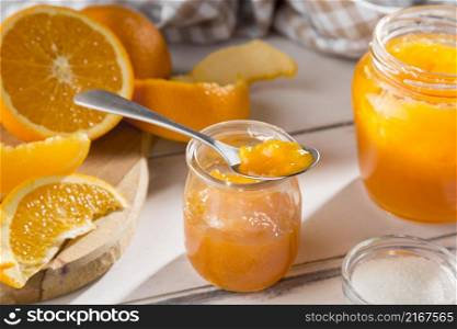high angle clear glass jar with orange jam