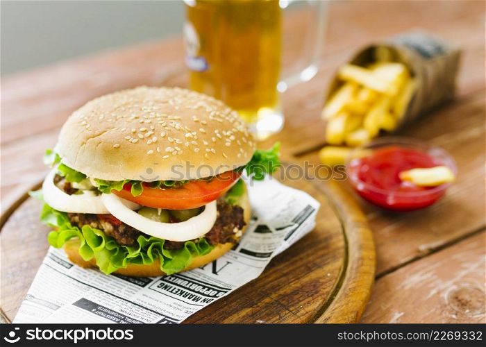 high angle close up burger with fries wooden board