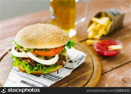 high angle close up burger with fries wooden board