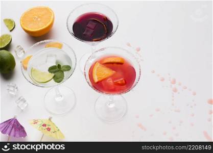 high angle cocktail glasses with salt rim lime