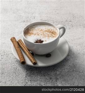 high angle coffee cup with cinnamon sticks star anise