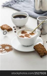 high angle coffee cups with desserts plate