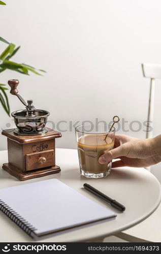 high angle coffee glass with grinder notebook table