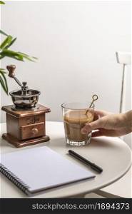 high angle coffee glass with grinder notebook table