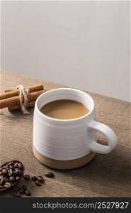 high angle coffee mug with cinnamon sticks