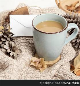 high angle coffee mug with pine cones autumn leaves