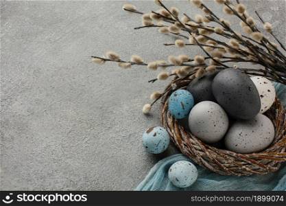 high angle colored easter eggs basket with copy space twigs. Resolution and high quality beautiful photo. high angle colored easter eggs basket with copy space twigs. High quality beautiful photo concept