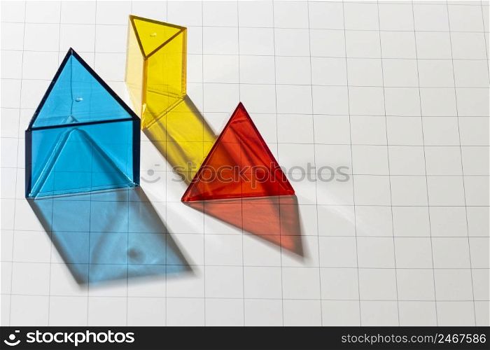 high angle colorful translucent geometric shapes with copy space