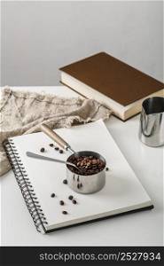 high angle cup with coffee beans notebook