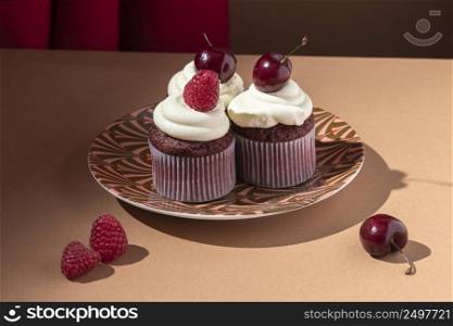 high angle cupcakes with cherry raspberry