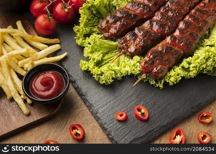 high angle delicious kebab slate with tomatoes fries