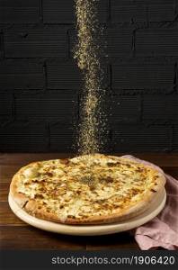 high angle dried herbs sprinkled pizza. High resolution photo. high angle dried herbs sprinkled pizza. High quality photo