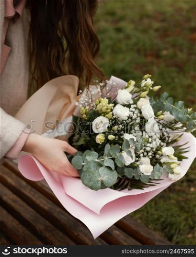 high angle elegant woman with bouquet flowers outdoors