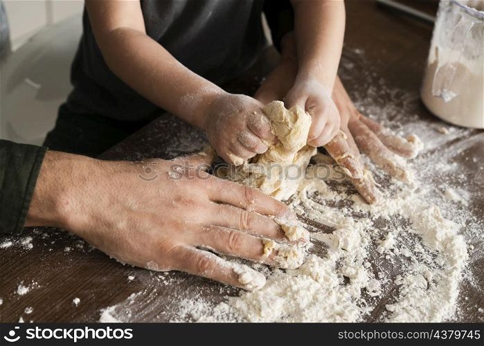high angle father son making dough
