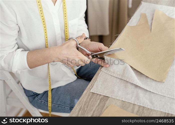 high angle female tailor working studio