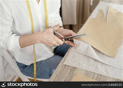 high angle female tailor working studio