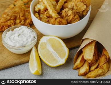 high angle fish chips bowl paper wrap with lemon